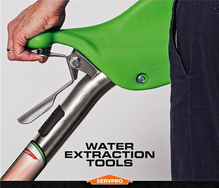 SERVPRO employee hand holding the top of a water extraction tool